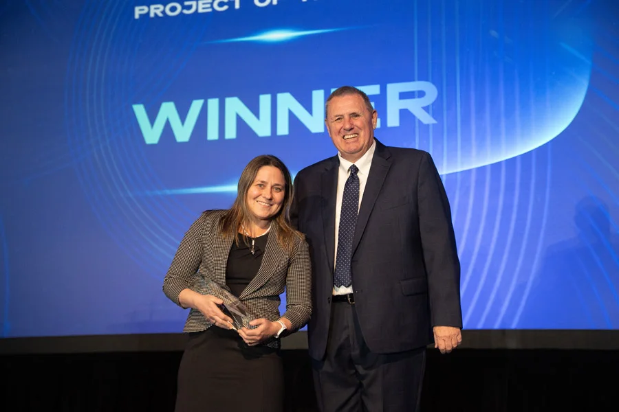 A winner accepting a SAPinsider Award on stage